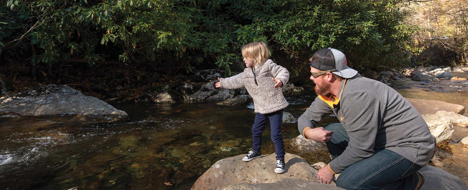 A father and son skip rocks while on a vacation at Great Smoky Mountains National Park in Tennesse