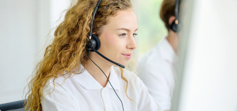 A Margaritaville Vacation Club representative wearing a headset working. 