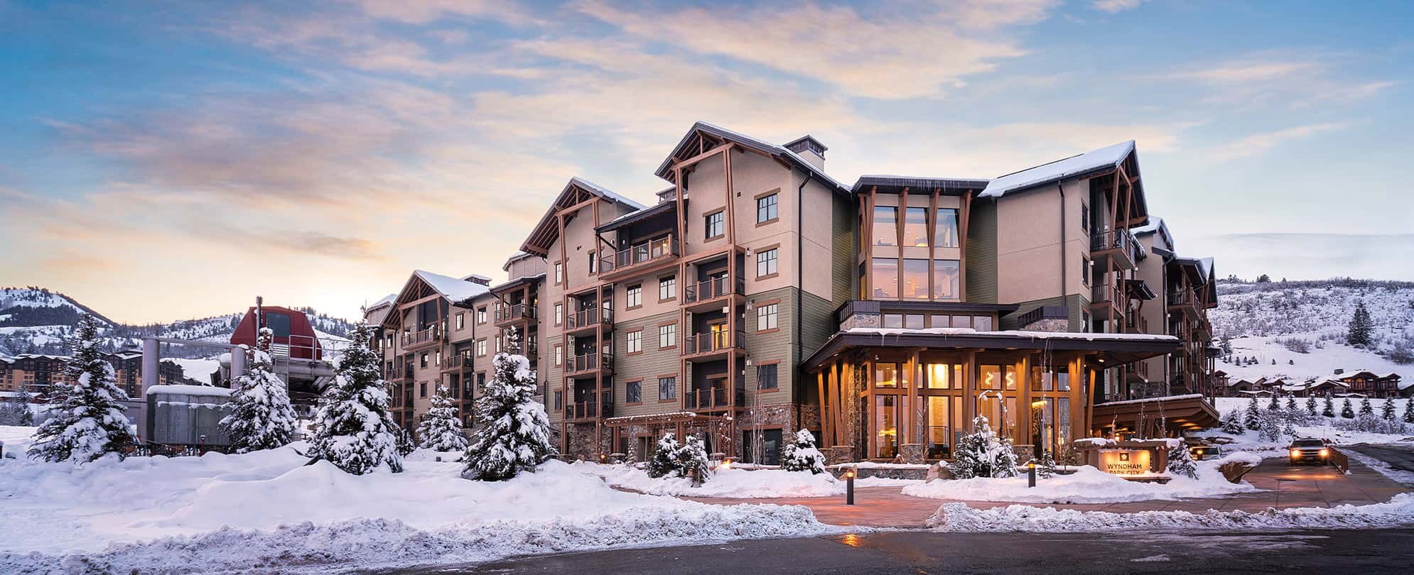 The exterior of Club Wyndham Park City, a timeshare resort, surrounded by snow during wintertime.