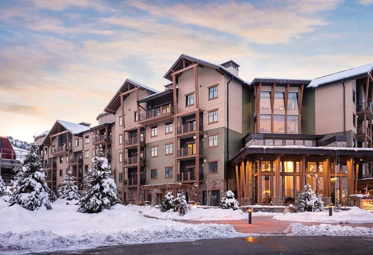 The exterior of Club Wyndham Park City, a timeshare resort, surrounded by snow during wintertime.