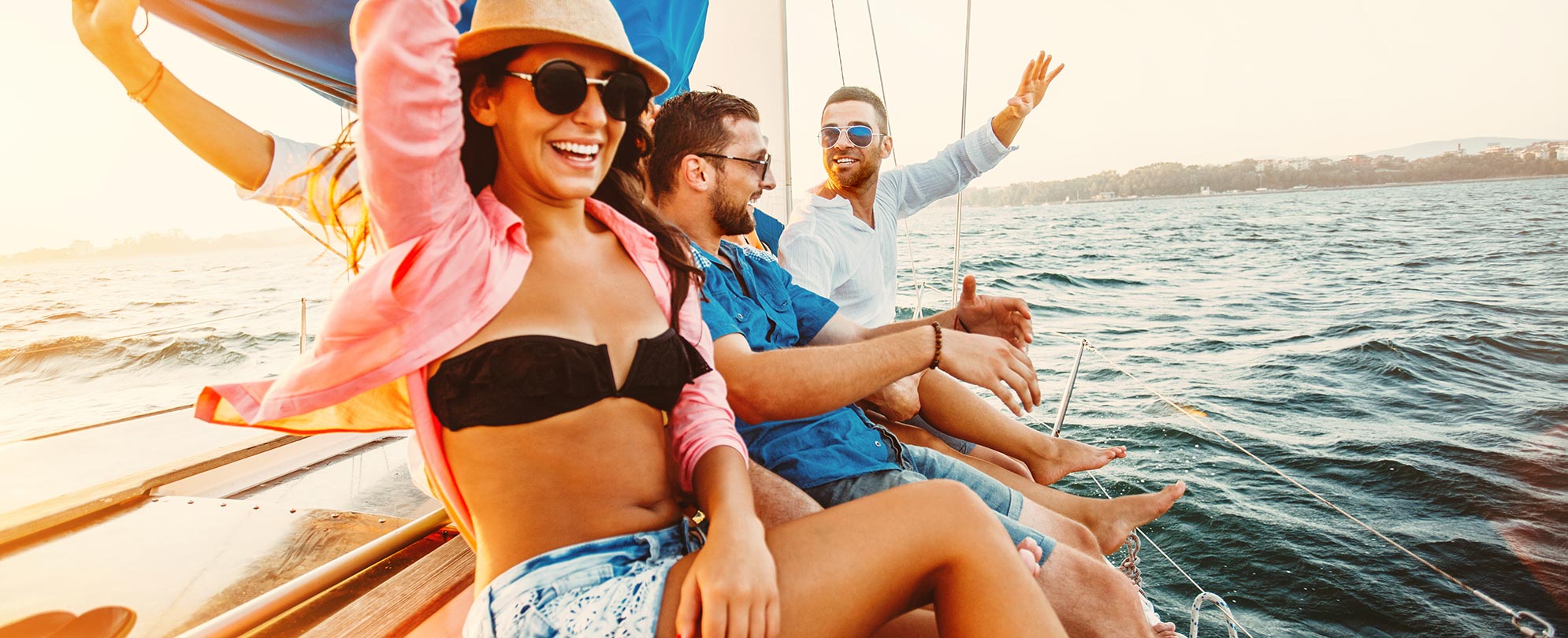 Young men and women ride on a sailboat during their Margaritaville vacation to St. Thomas, U.S. Virgin Islands.