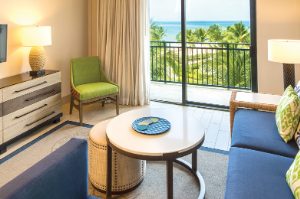 Suite living room with a sliding door to an oceanview balcony at Margaritaville Vacation Club by Wyndham - Rio Mar.